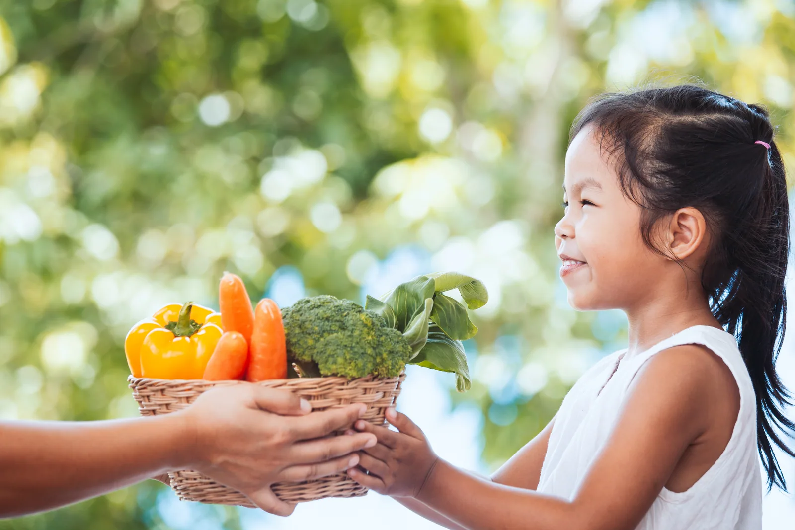 A farming parent sharing fresh vegetables with a child